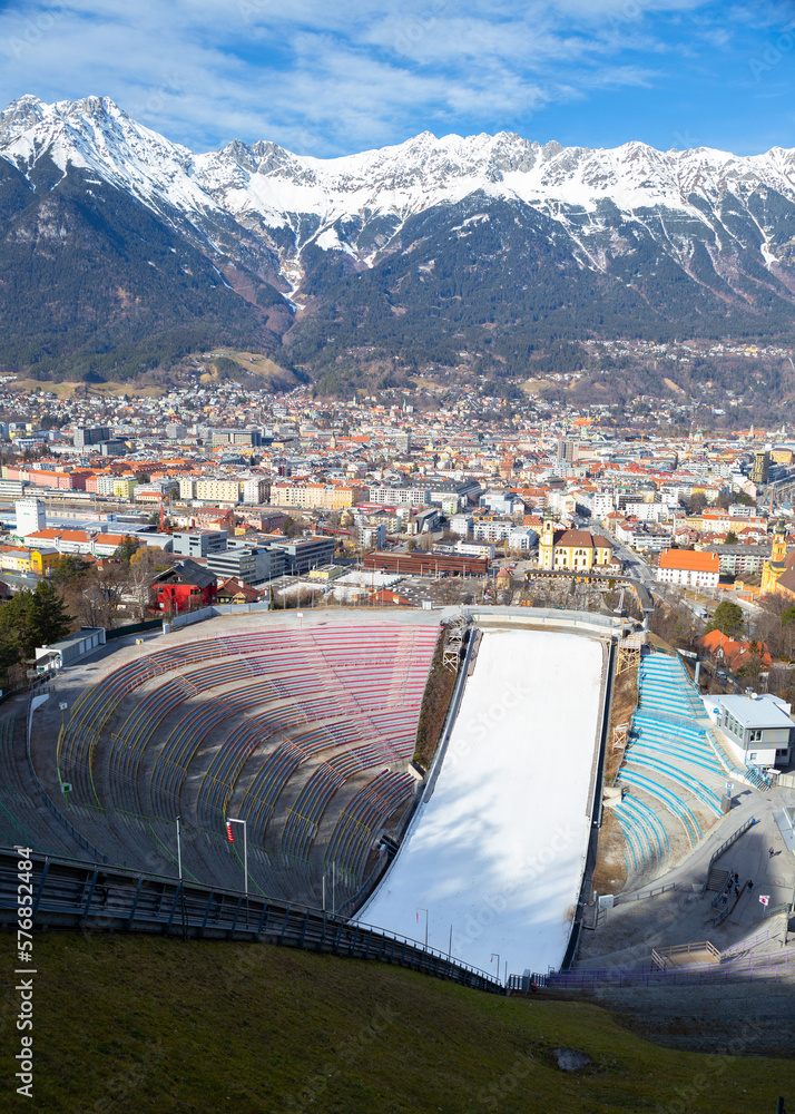 Arial view of bergisel ski jump and Innsbruck old town with mountain range in winter