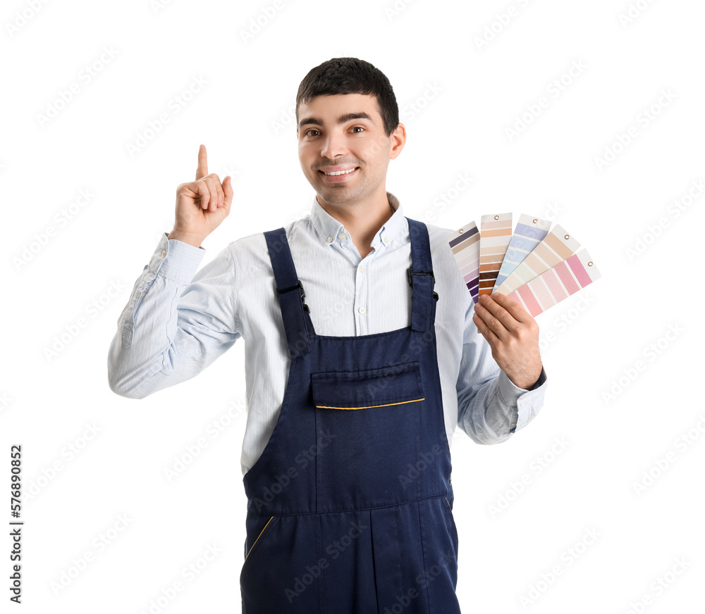 Male painter with color palettes pointing at something on white background