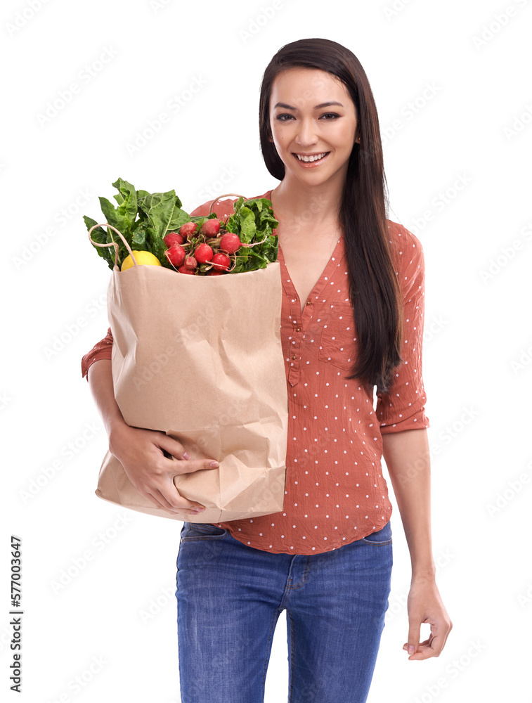 A happy female model with a smiling face following a vegetables diet and holding a shopping bag fill