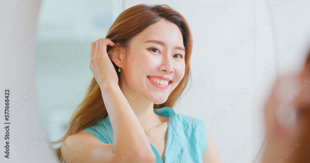 woman is looking in mirror