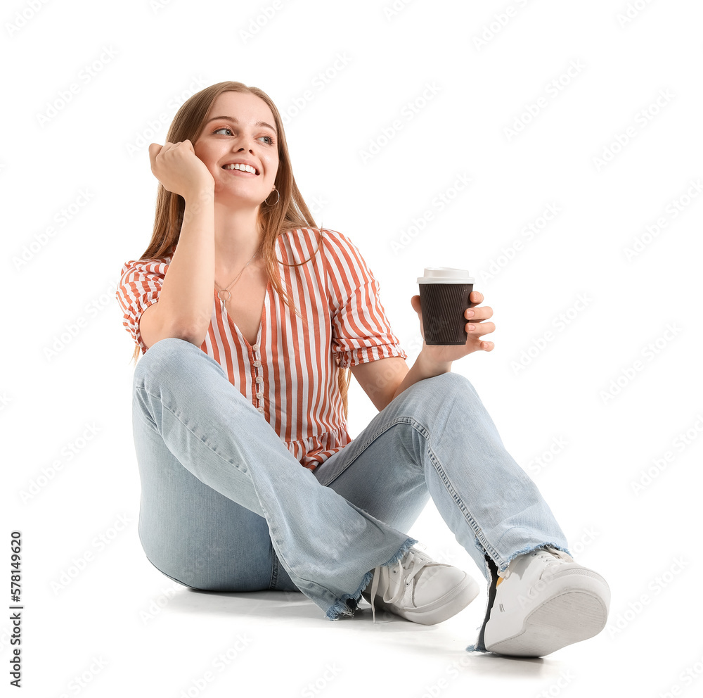 Beautiful girl with cup of coffee sitting on white background