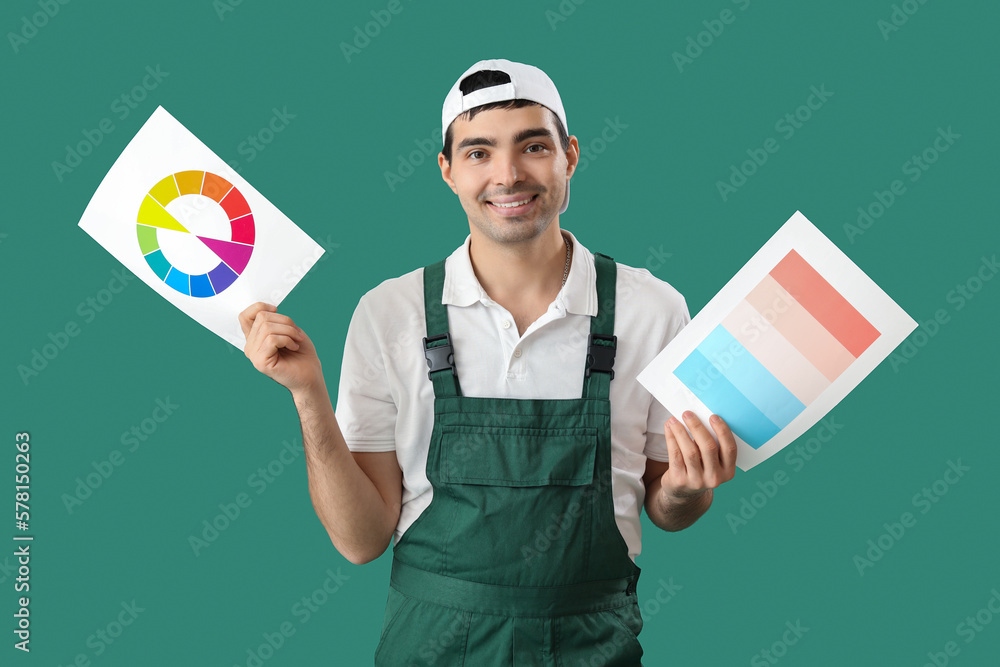 Male painter with color palettes on green background