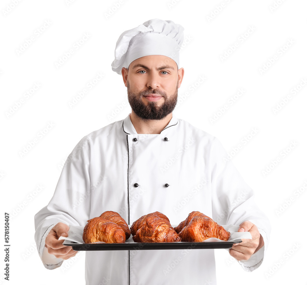 Male baker with tray of tasty croissants on white background