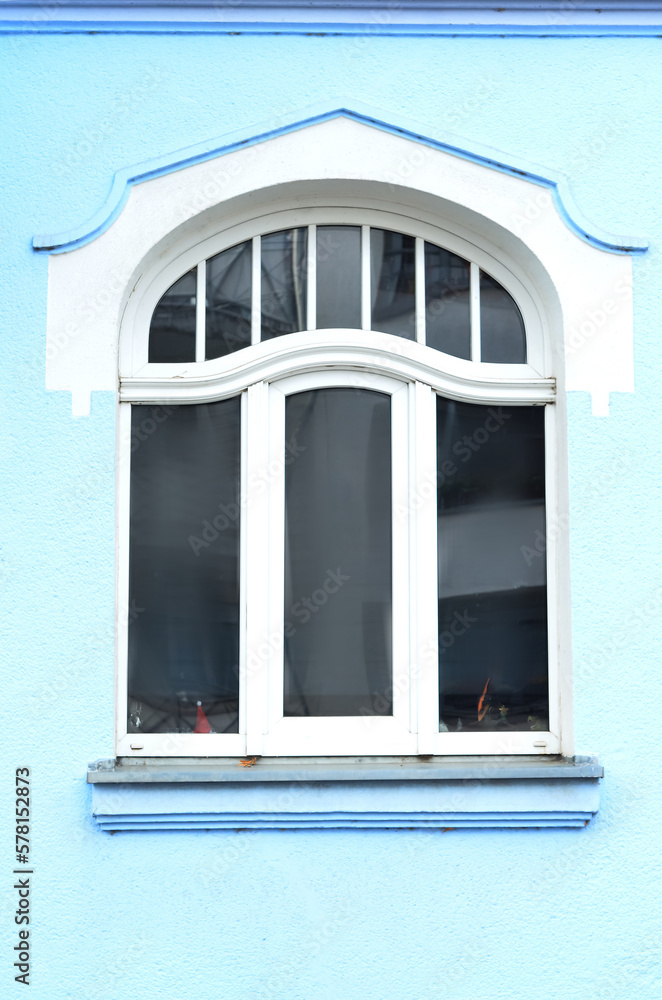 View of blue building with white window