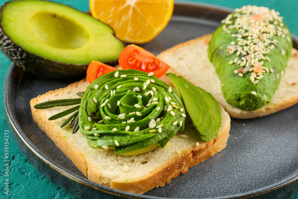 Plate with delicious avocado toast on green background, closeup