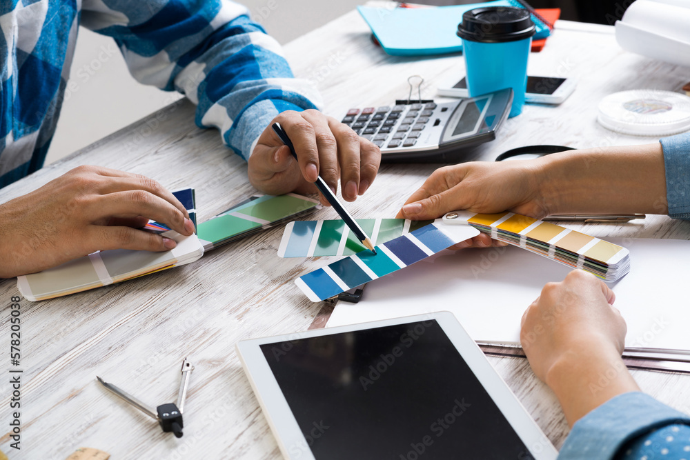 Designers discussing color palette at desk