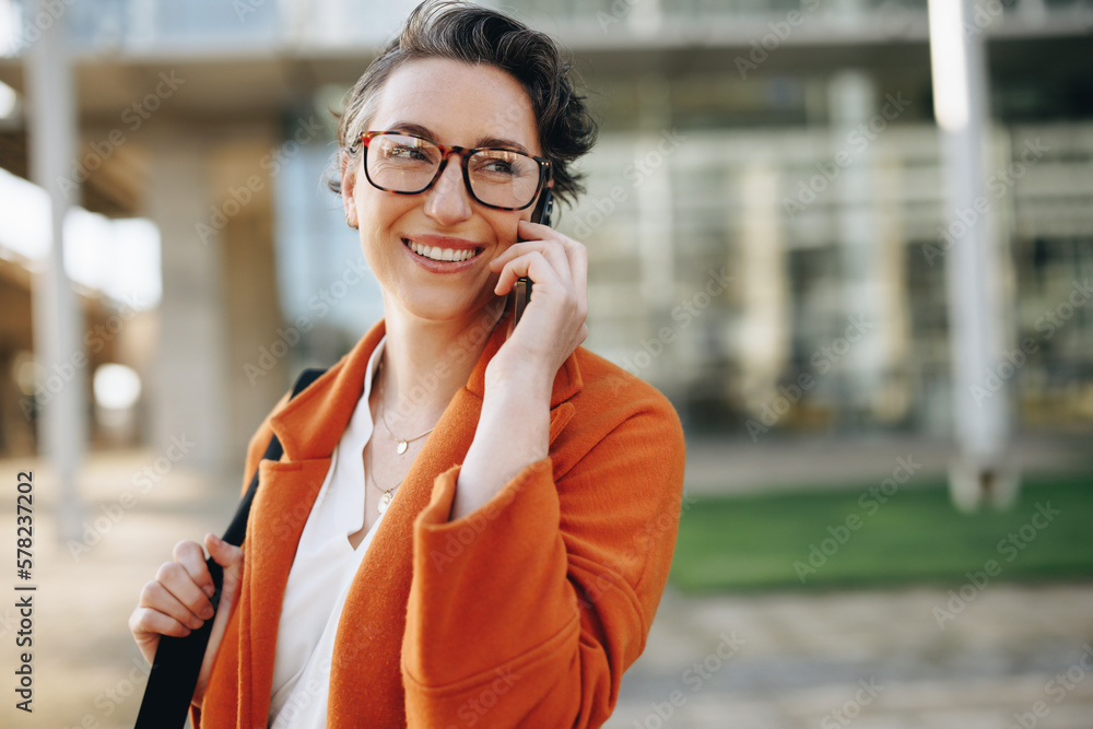 Smiling business woman speaking on the phone while commuting to the office