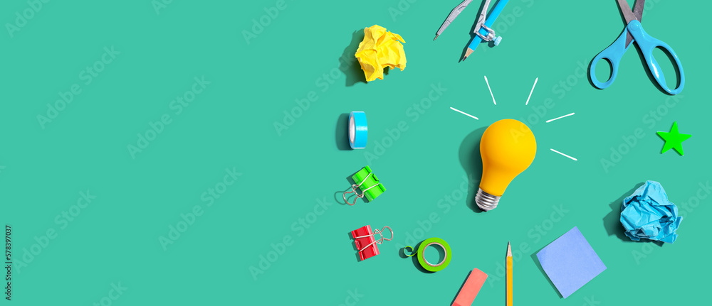 Idea light bulb with school supplies overhead view - flat lay