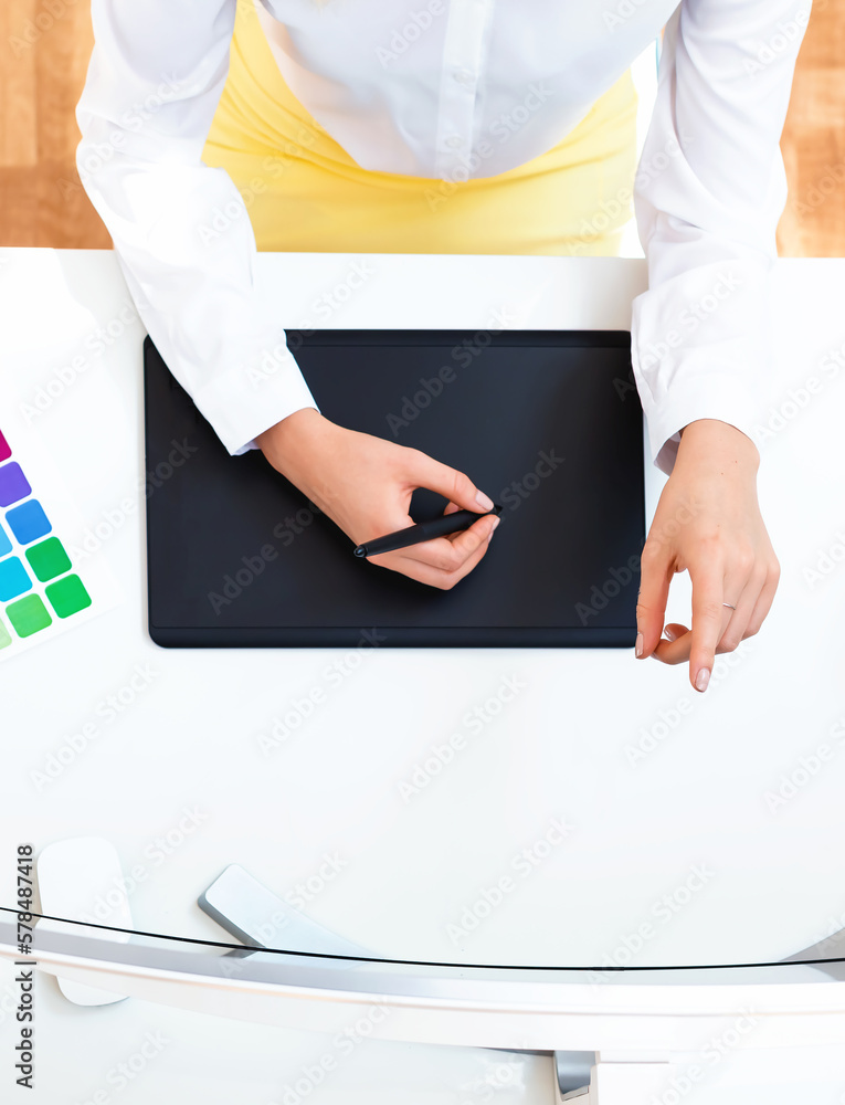 Graphic designer using her graphic tablet in an office