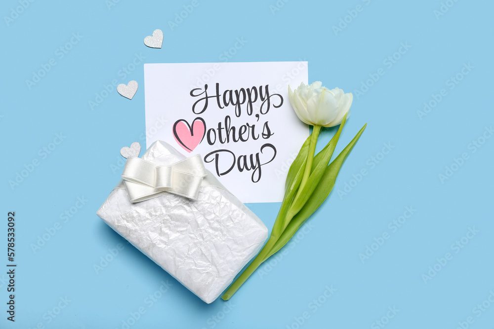 Card with text HAPPY MOTHERS DAY, beautiful gift box and tulip flower on color background