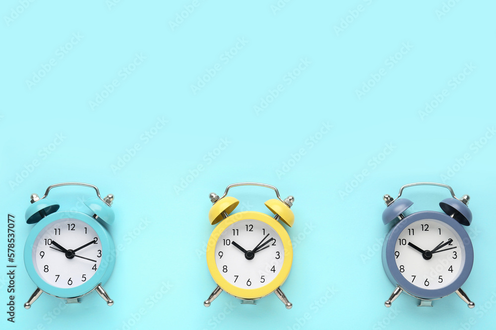 Alarm clocks on blue background