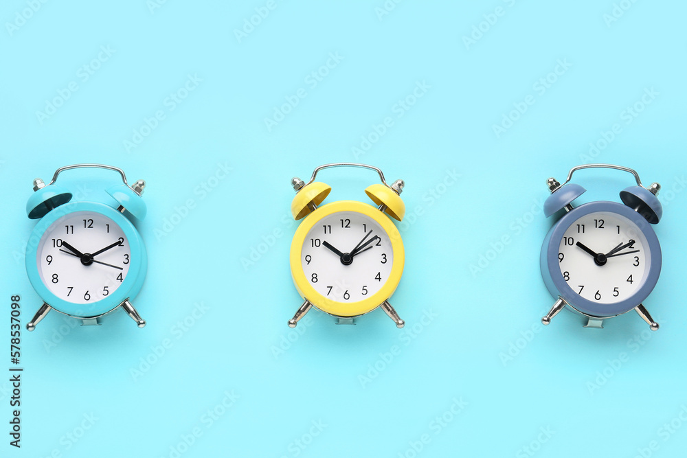 Alarm clocks on blue background