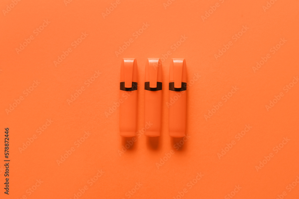 Permanent markers on orange background