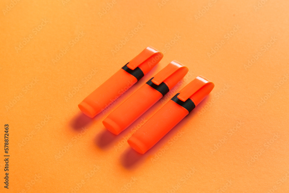 Permanent markers on orange background