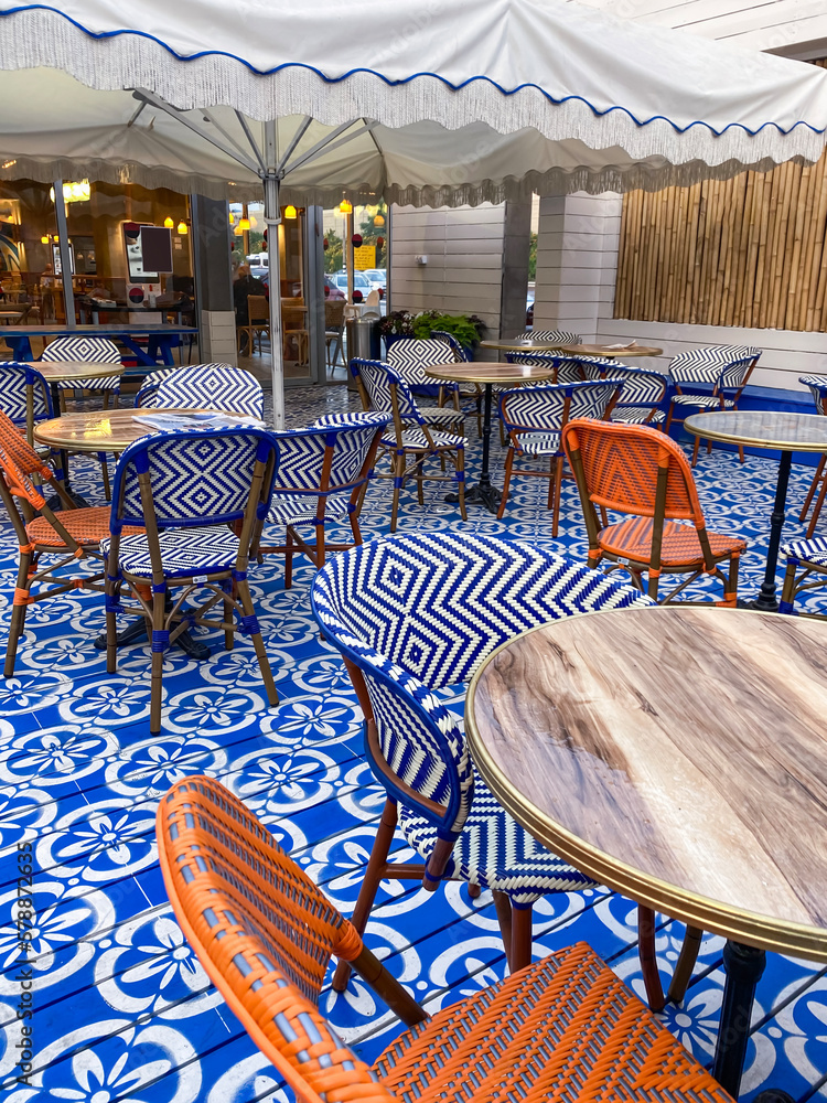 View of beautiful street cafe with chairs and tables