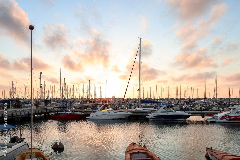 View of beautiful pier with yachts at sunset