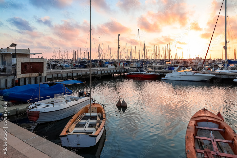 View of beautiful pier with yachts at sunset