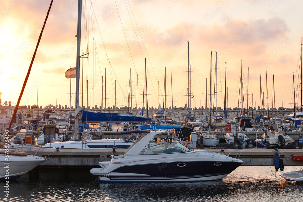 View of beautiful pier with yachts at sunset