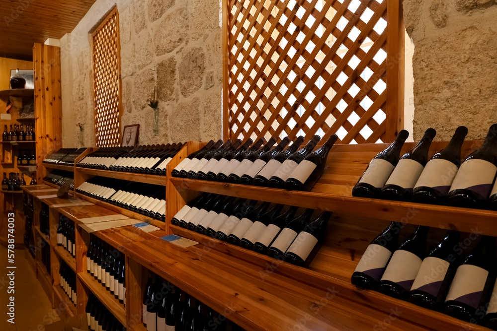 Wooden storage stand with bottles of wine in store