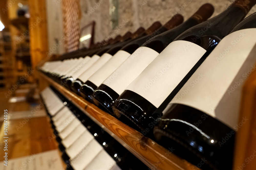 Wooden storage stand with bottles of wine in store, closeup