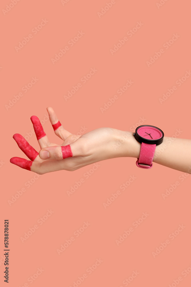 Woman with painted fingers and stylish wristwatch on pink background