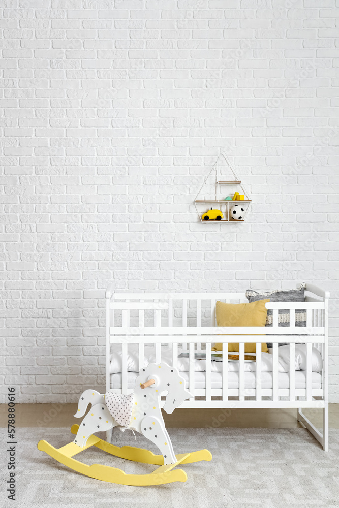 Interior of childrens bedroom with crib and rocking horse