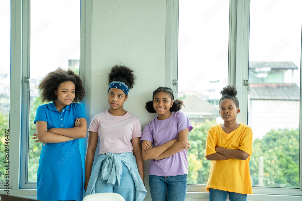 Group of African American elementary school kid primary school boys and girls are studying in class.