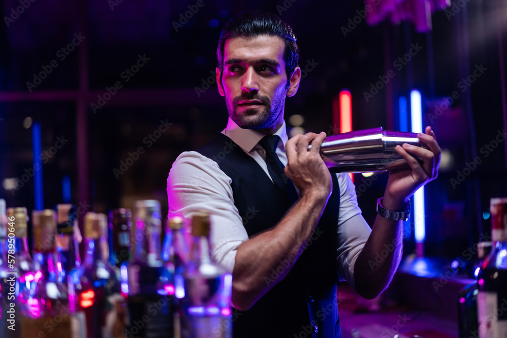 Caucasian profession bartender making a cocktail for women at a bar. 