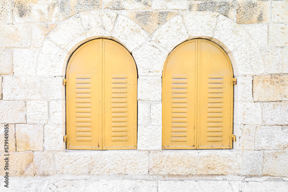 View of old building with yellow window shutters