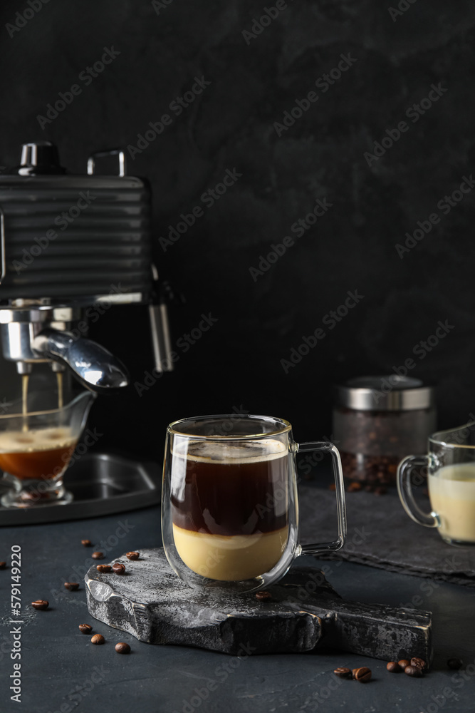 Cup of delicious Cafe Bombon on dark background