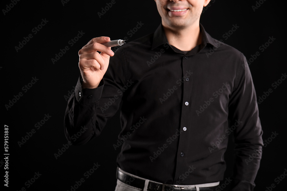 Business consultant with marker using virtual screen on dark background, closeup