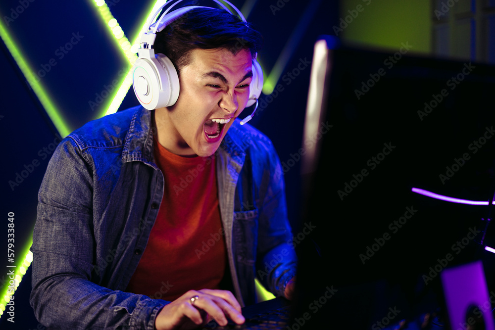 Gamer shouting in an intense moment of a pc gaming session