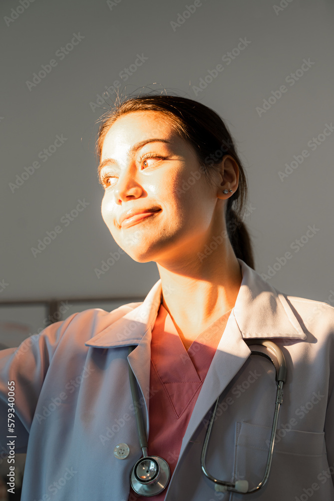 Female doctor and sunshine,Women medical staff worker relax smiling stand in clinic office in hospit