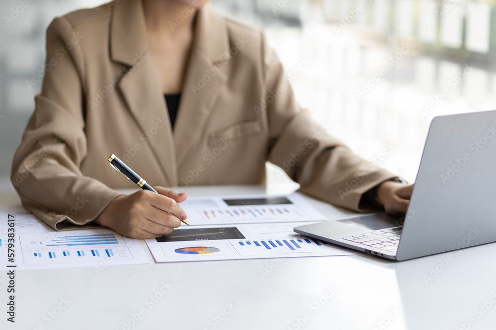 Businesswoman working with financial accounting documents in the office.