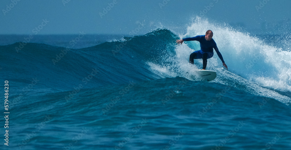 Surfer rides the wave in the Maldives