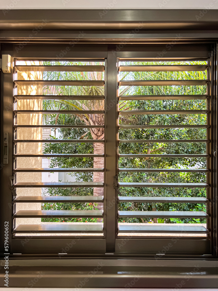 Window with black blinds in room