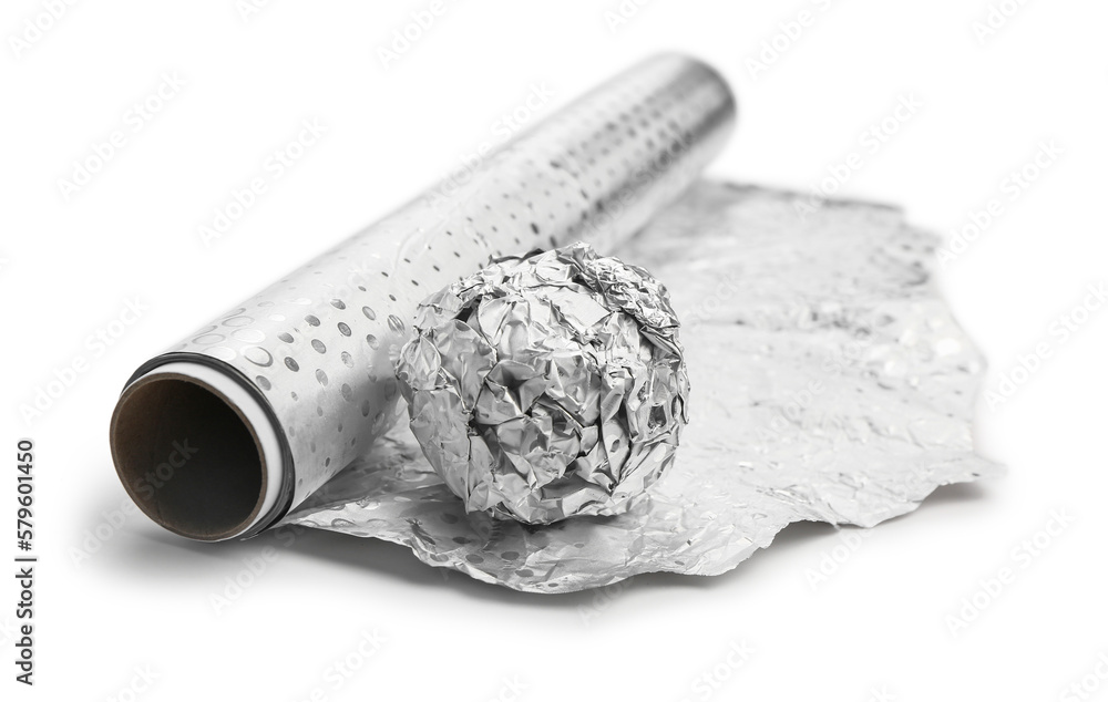 Roll and ball of aluminium foil on white background