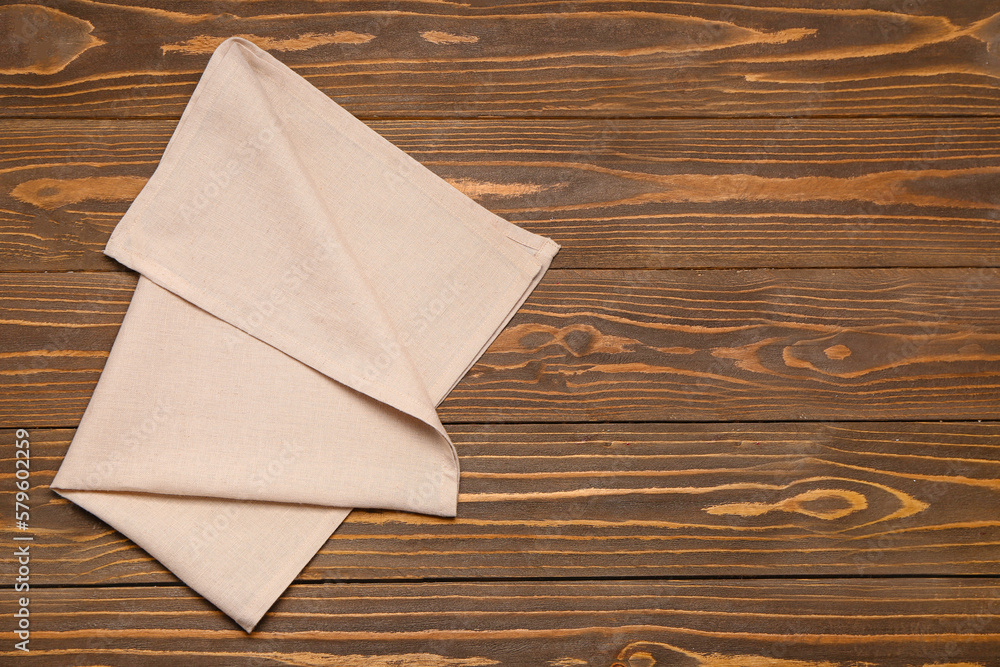 Folded napkin on wooden background