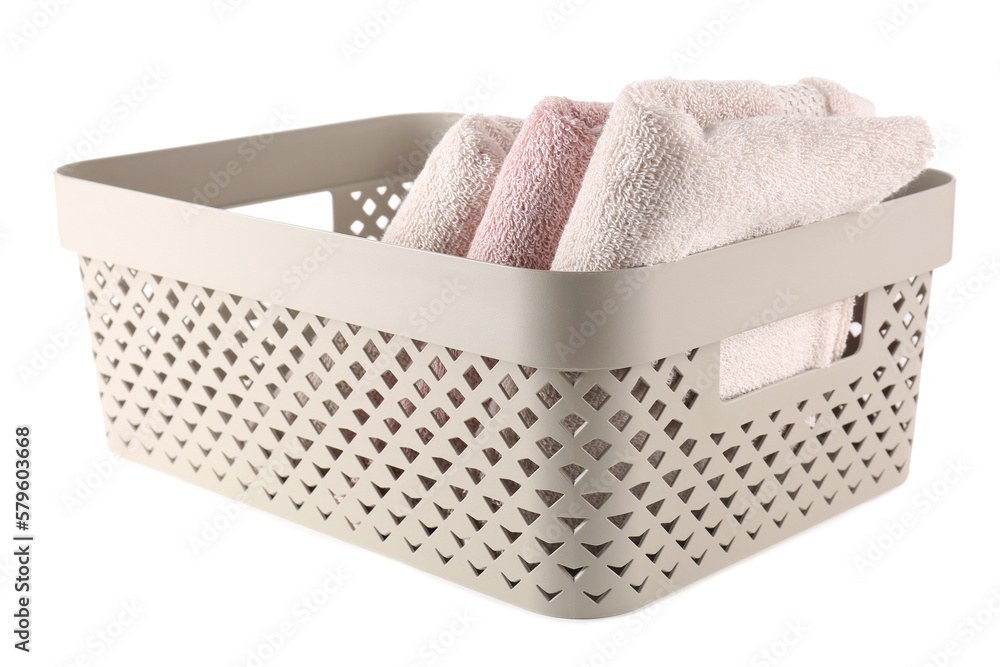 Basket with folded soft towels isolated on white background