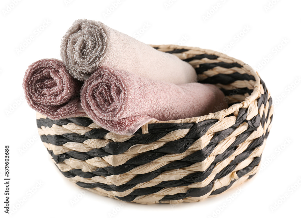 Basket with rolled soft towels isolated on white background