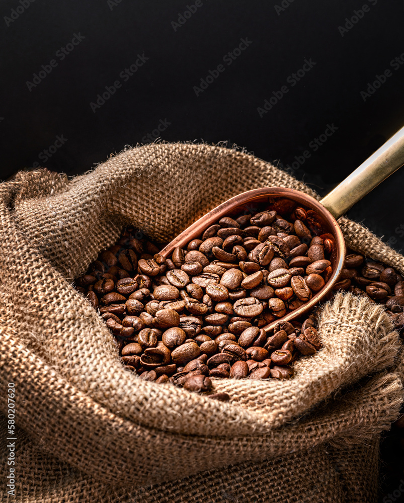 Scoop of coffee beans in a bag on dark board. Ground coffee in a cup and instant coffee in a wooden 