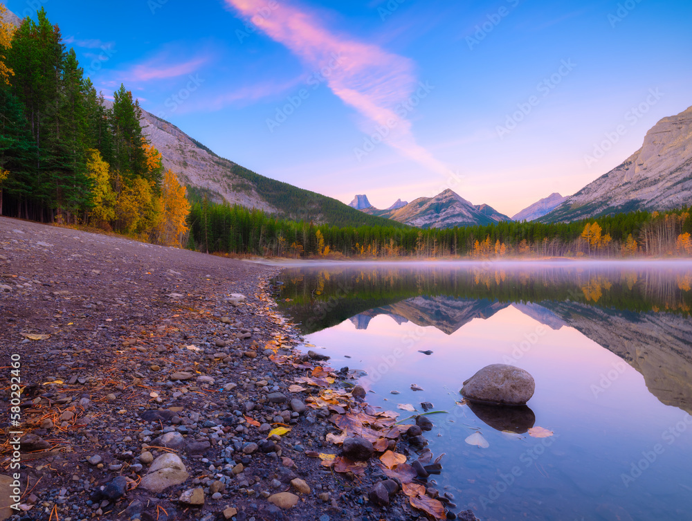 Lake and mountains in a valley at dawn. Reflections on the surface of the lake. Mountain landscape a