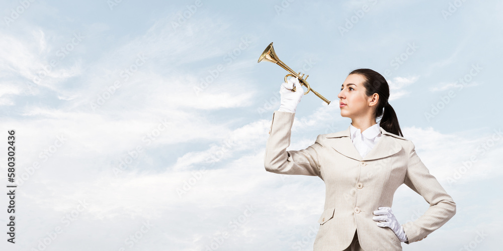 Beautiful woman playing trumpet brass