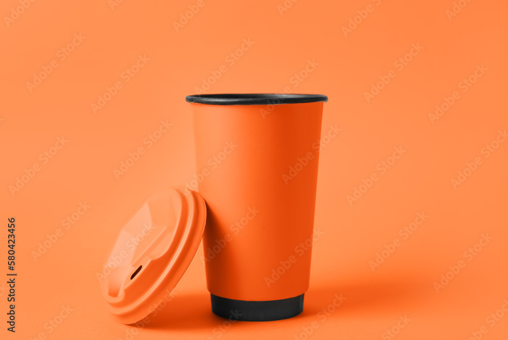 Takeaway cup for drink on orange background