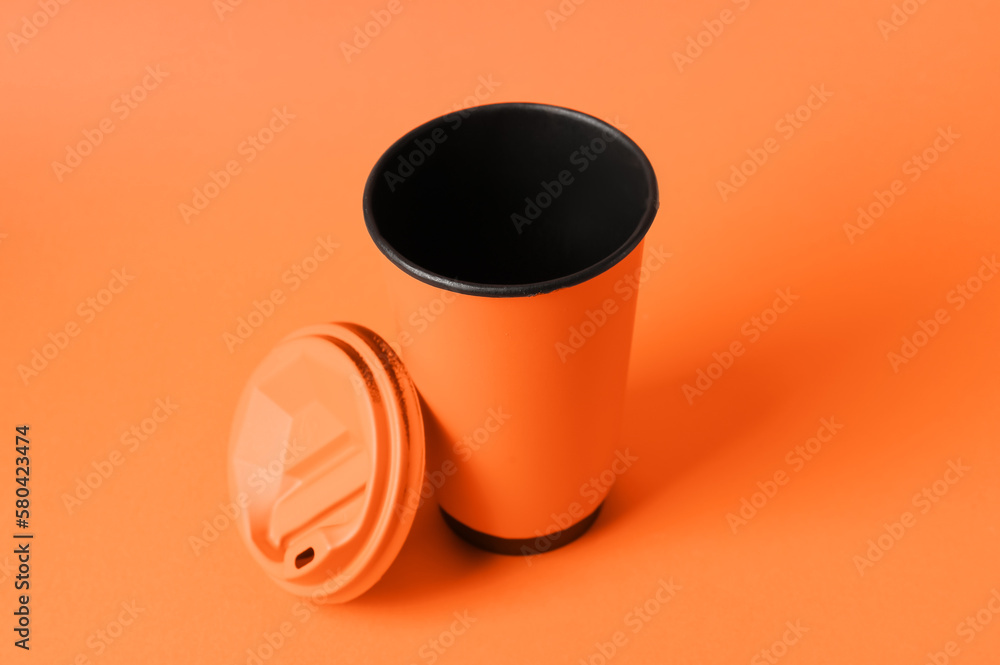 Takeaway cup for drink on orange background