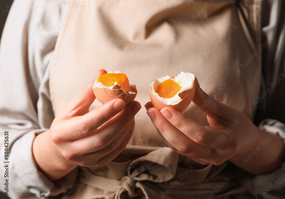 Woman with boiled egg, closeup