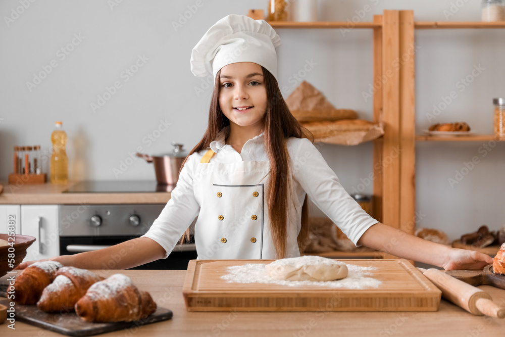 Little baker cooking in kitchen