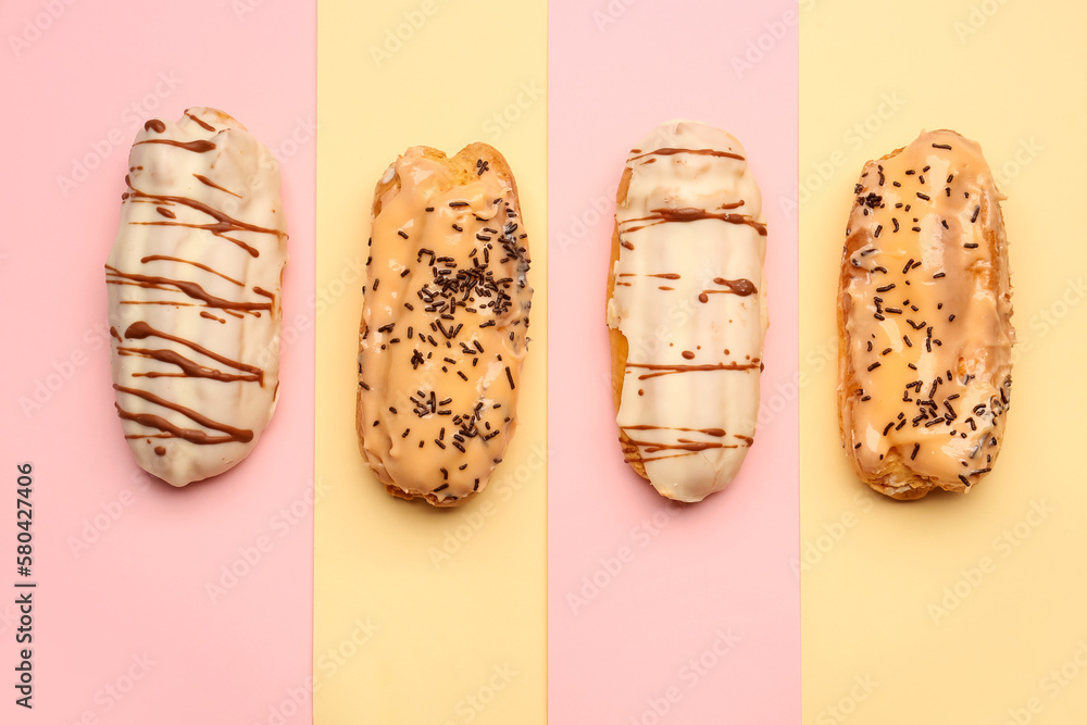 Tasty glazed eclairs on yellow and pink background