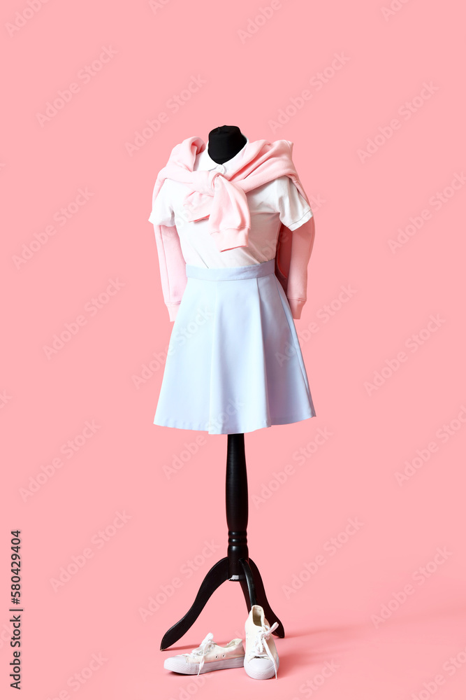 Mannequin with stylish clothes on pink background