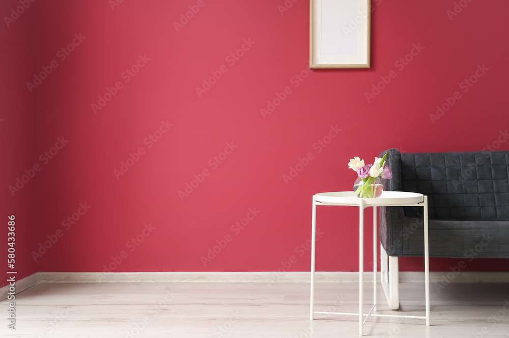 Interior of living room with black sofa and table